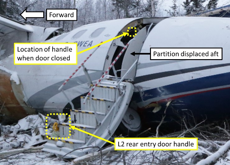 Partition displaced toward the aft, blocking access to the L2 rear entry door handle (Source: TSB)