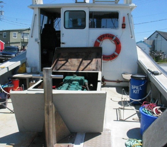 View of the wheelhouse from aft showing raised coaming around engine compartment and one of the hatch covers (Source: Third party, with permission)