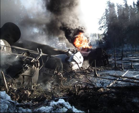 Photo of fire and tank car with thermal tear